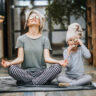 A smiling person doing yoga or holding healthy food with nature in the background.